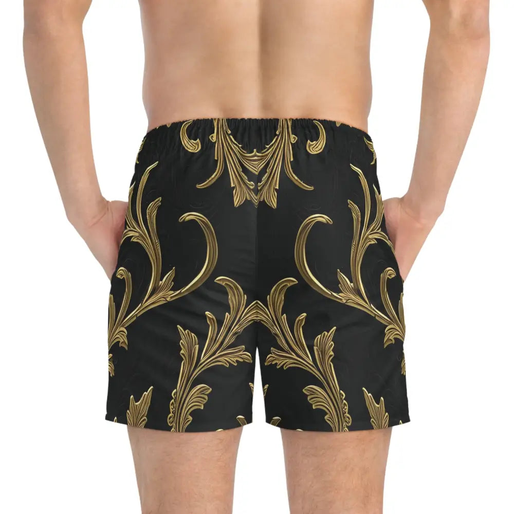 Patterned swim trunks in black and gold featuring luxurious baroque flourish design
