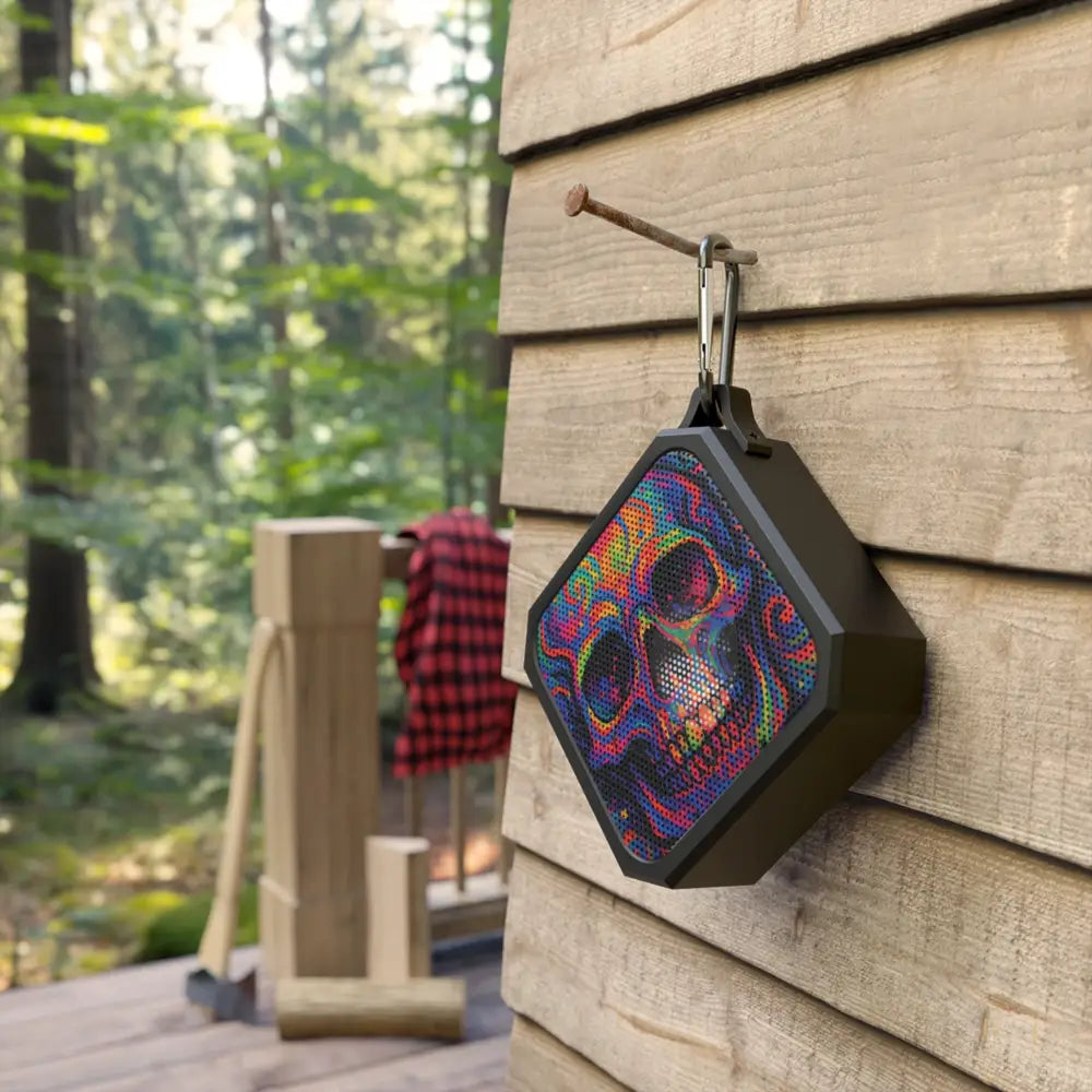 Portable Bluetooth speaker with psychedelic skull pattern for festival audio experiences