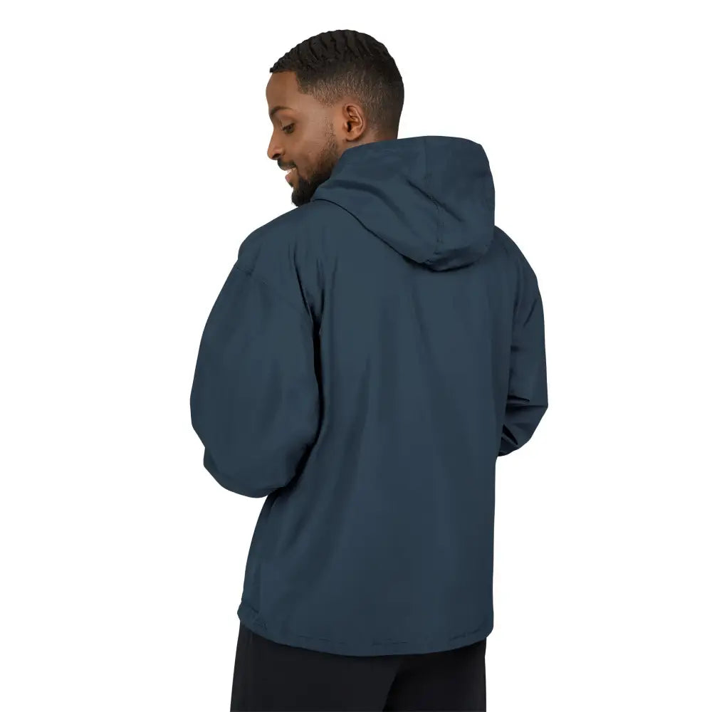 Man wearing dark teal Champion Packable Anorak Jacket with flaming pumpkin design