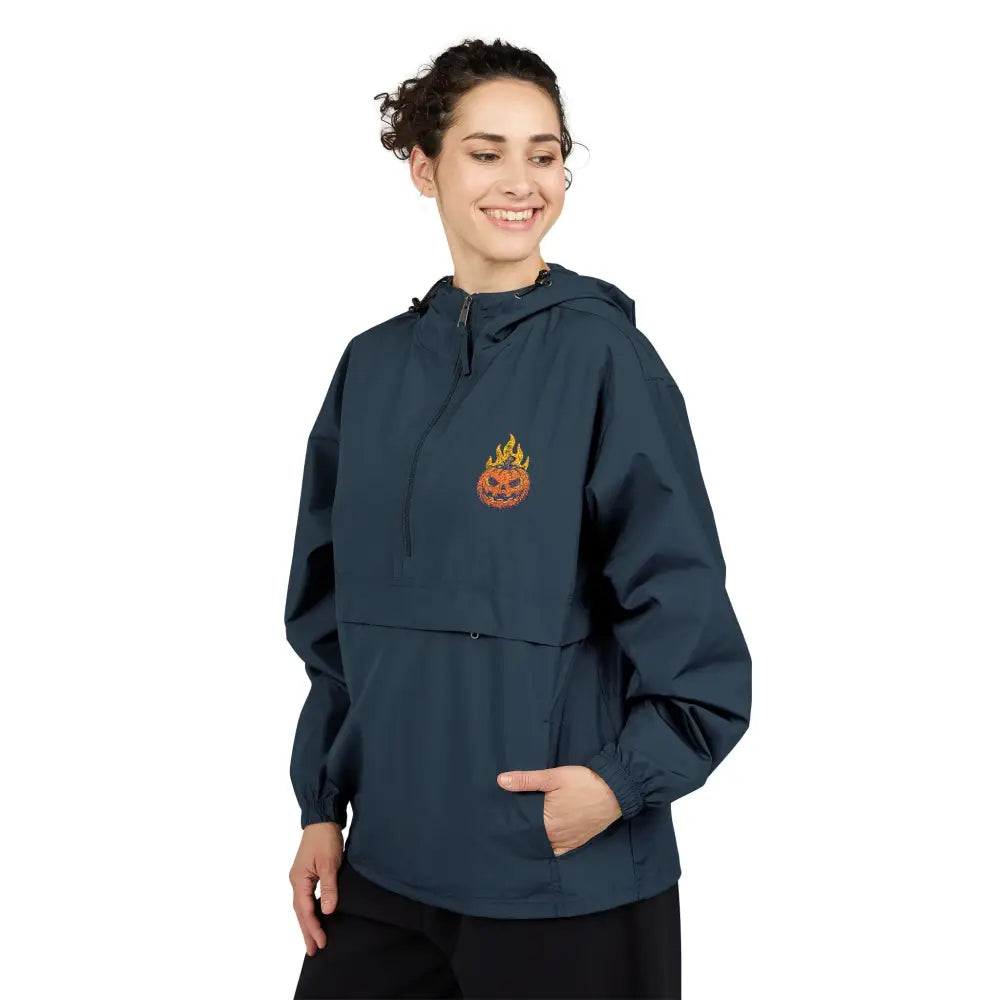 Woman wearing Champion Packable Anorak Jacket with flaming pumpkin and flame logo