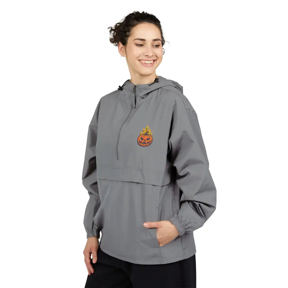 Woman wearing Champion Packable Anorak Jacket with flaming pumpkin graphic for Halloween