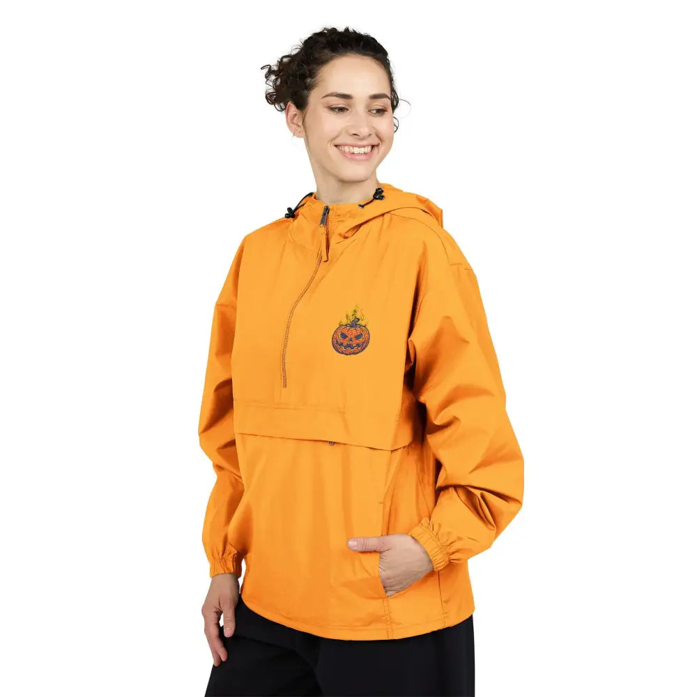 Women’s orange champion packable anorak jacket with flaming pumpkin Halloween design