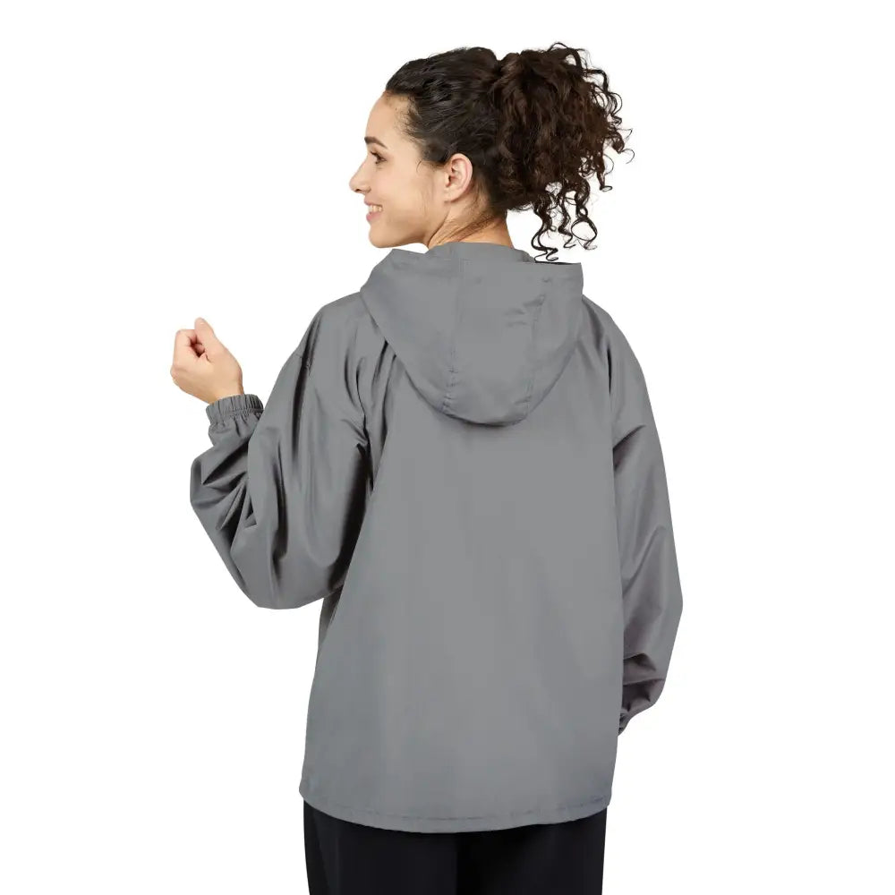 Woman in gray champion packable anorak jacket with black pants, flaming pumpkin design