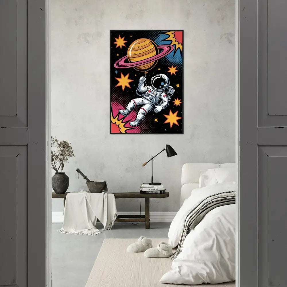 Colorful framed poster on matte white paper featuring an astronaut, ringed planet, and stars