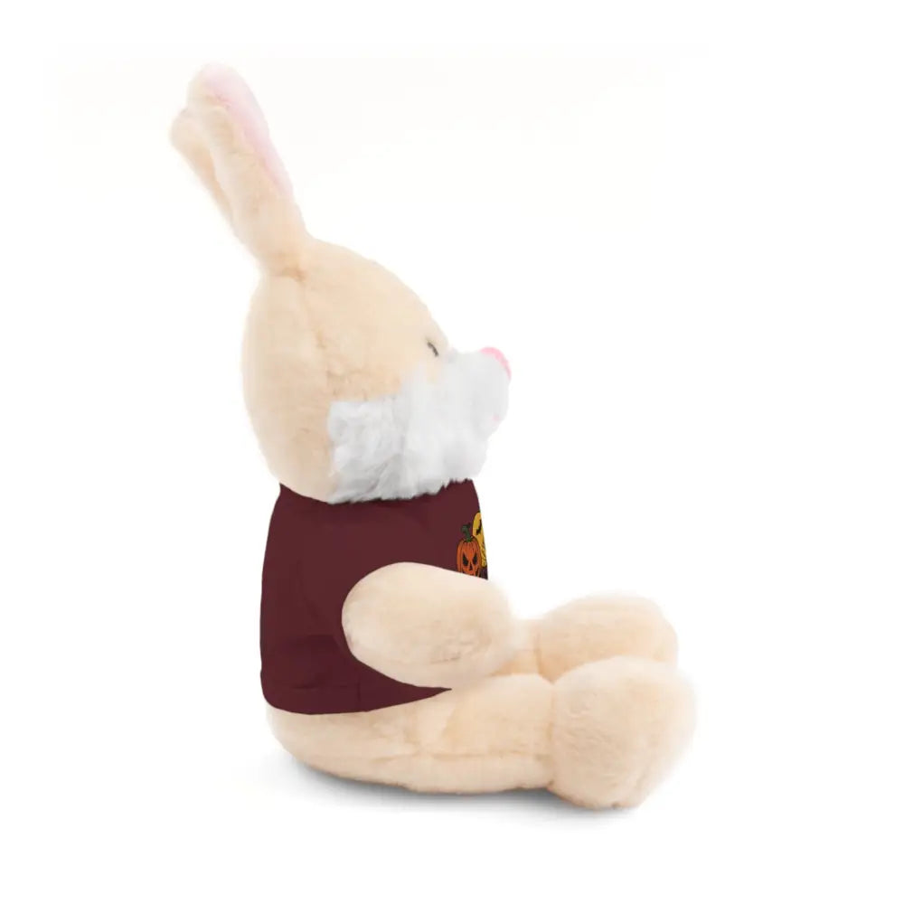 Cream-colored plush bunny wearing a maroon fall-themed haunted house tee, collectible plush toy