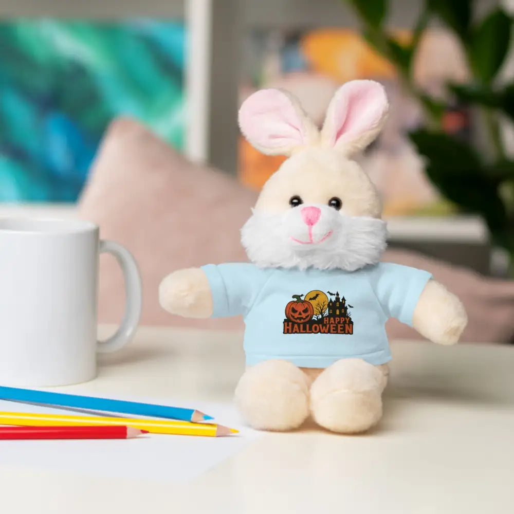 Cream-colored plush bunny with pink ears and nose wearing a Halloween haunted house tee