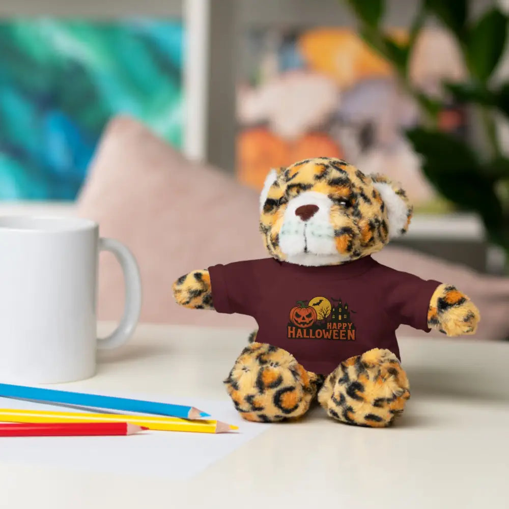Leopard print plush toy wearing maroon Halloween T-shirt with haunted house design