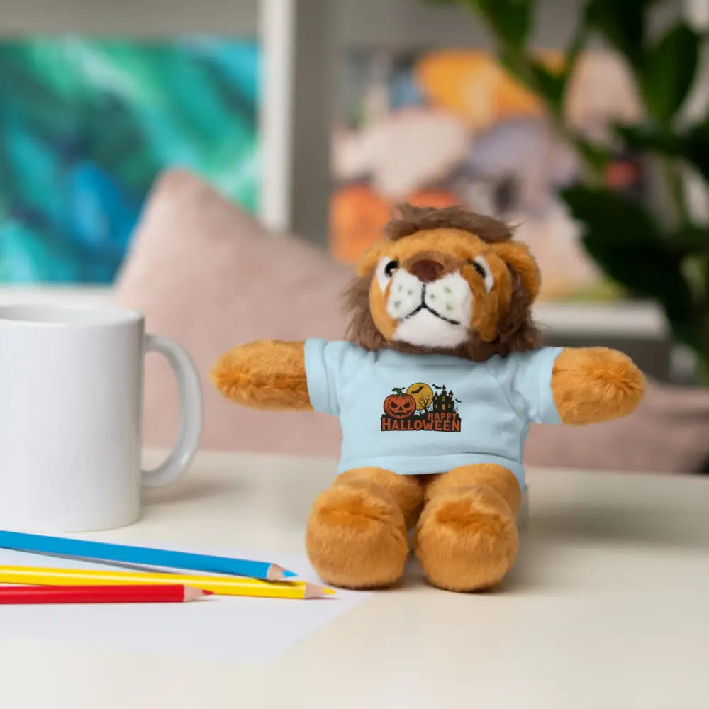 Plush lion toy with haunted house Halloween graphic on light blue tee, collectible plush