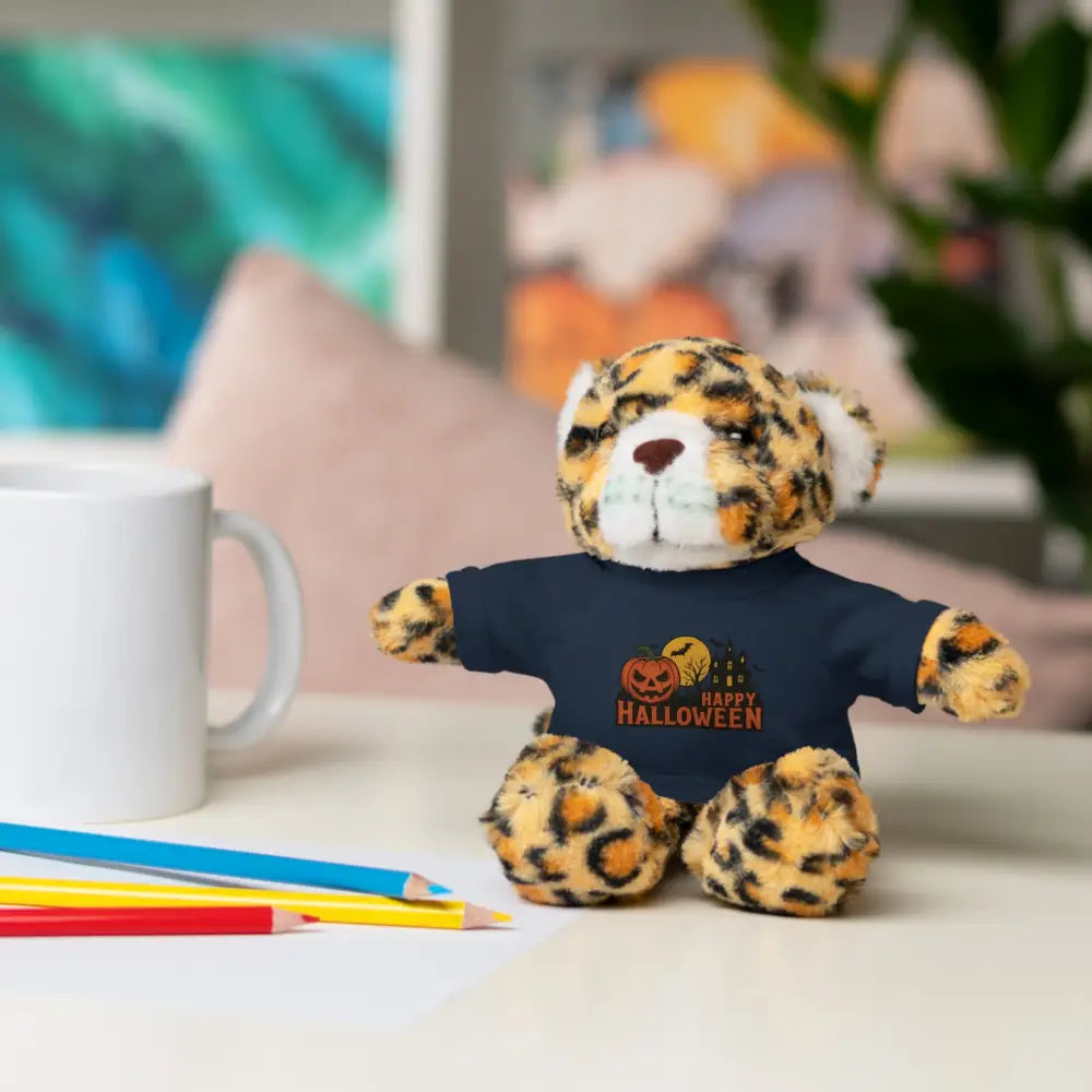 Leopard print plush toy wearing dark blue Happy Halloween T-shirt, haunted house design