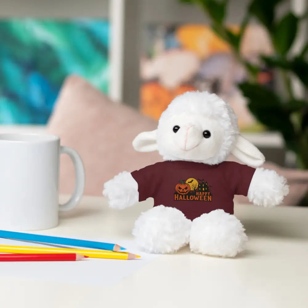 White fluffy lamb plush toy with haunted house Halloween graphic wearing maroon tee