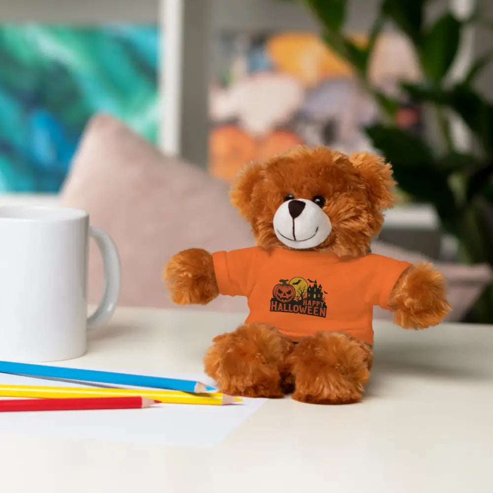 Fluffy brown teddy bear wearing orange T-shirt with haunted house design, collectible plush