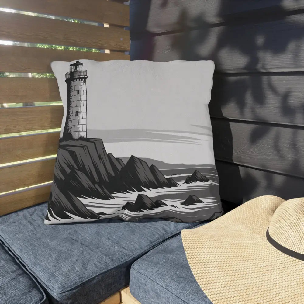 Decorative outdoor pillow with lighthouse and rocky coastline design in vibrant colors