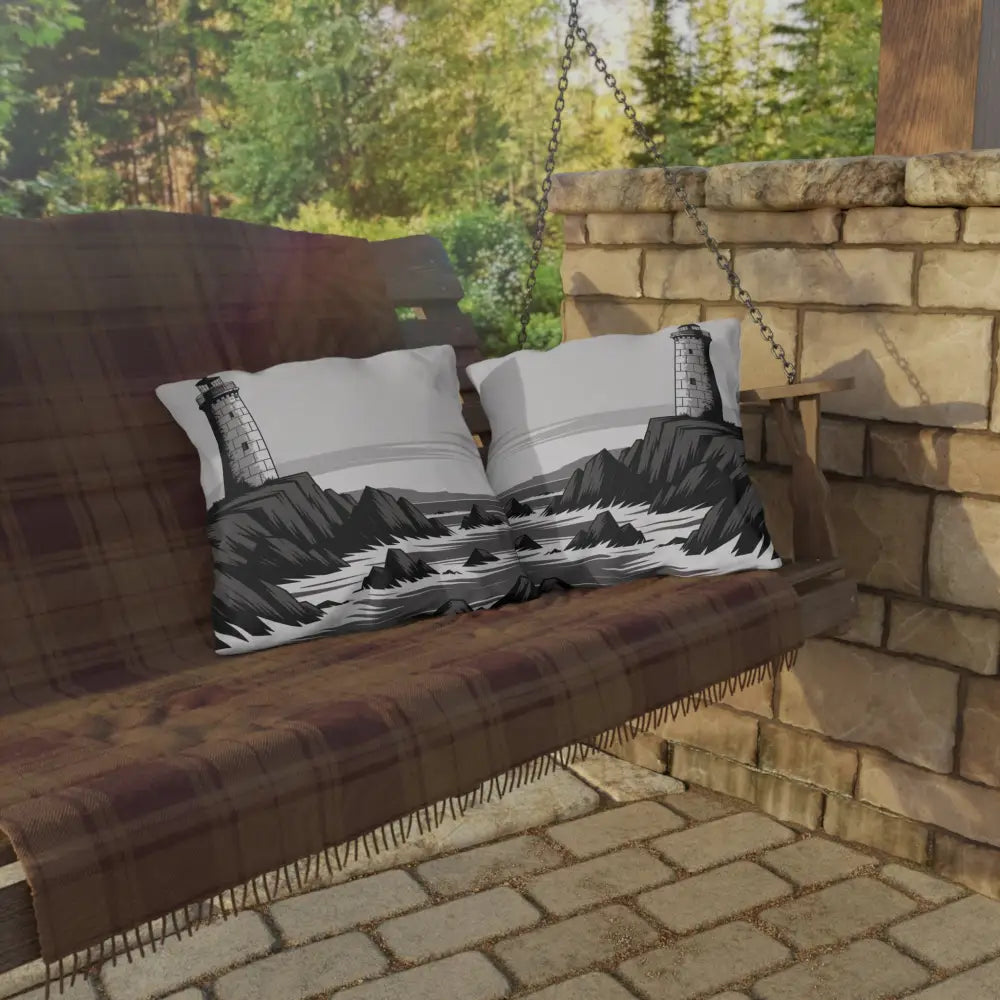 Wooden porch swing with vibrant outdoor pillows, plaid blanket, lighthouse-themed cushions