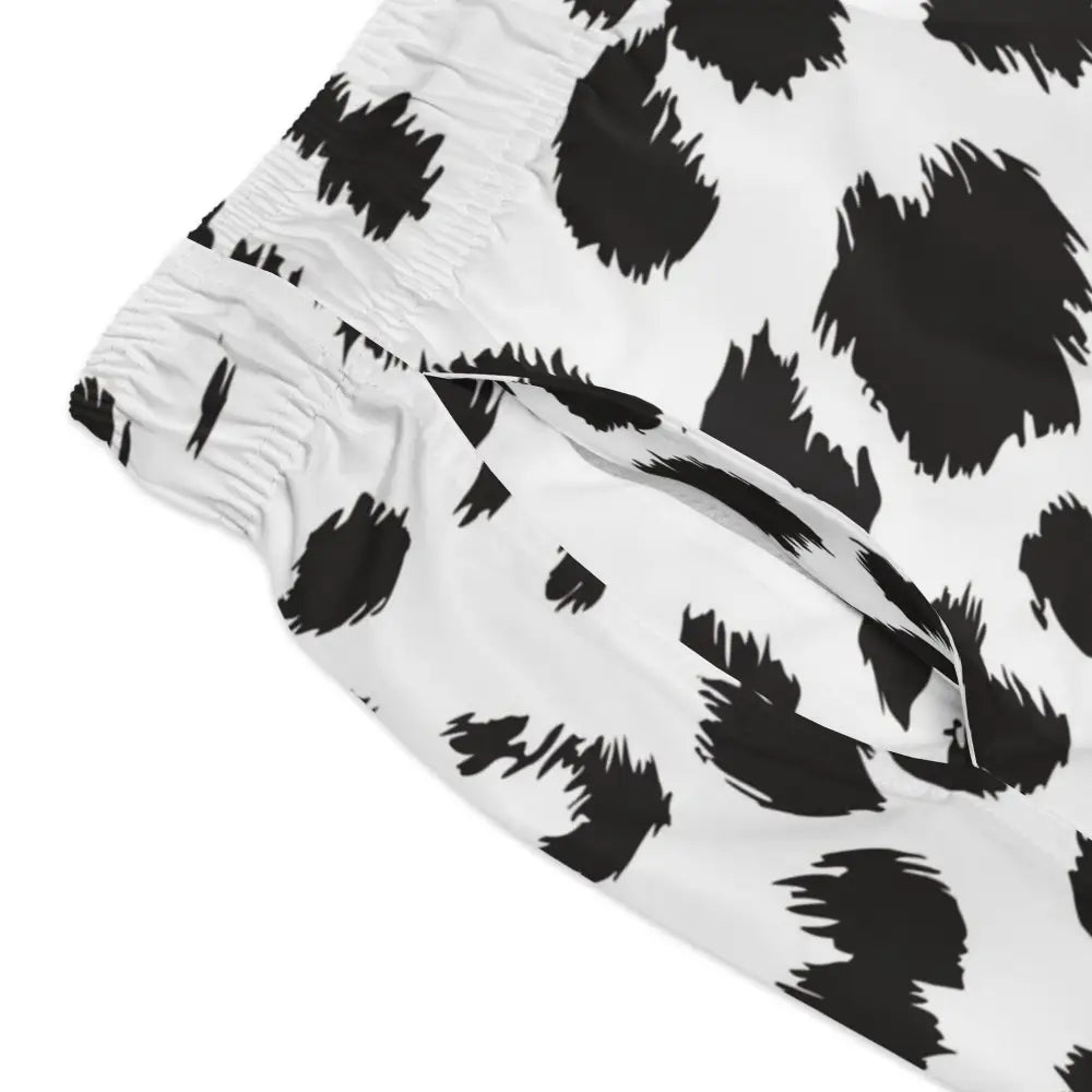Men’s white swim trunks with black leopard print from PixiOnyx Beachwear