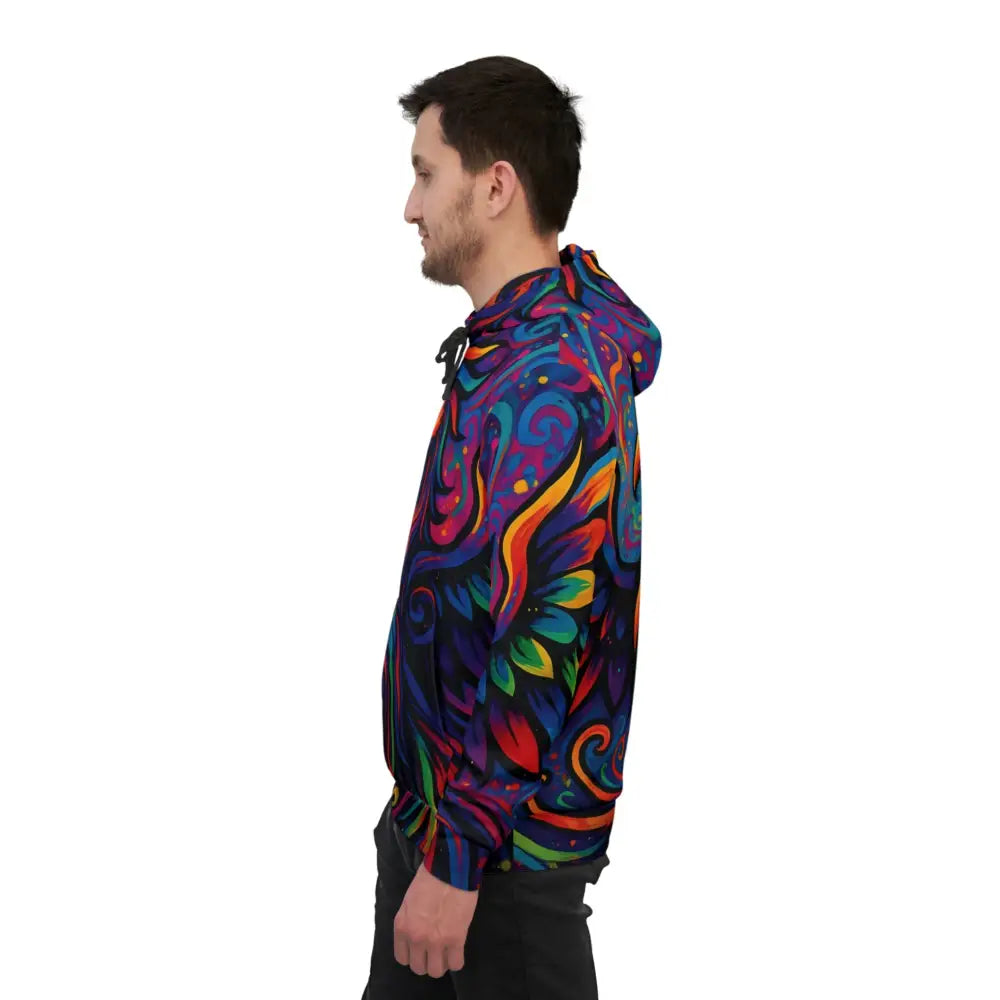 Man wearing a vibrant psychedelic swirl patterned hoodie from PixiOnyx AOP Festival Hoodie collection