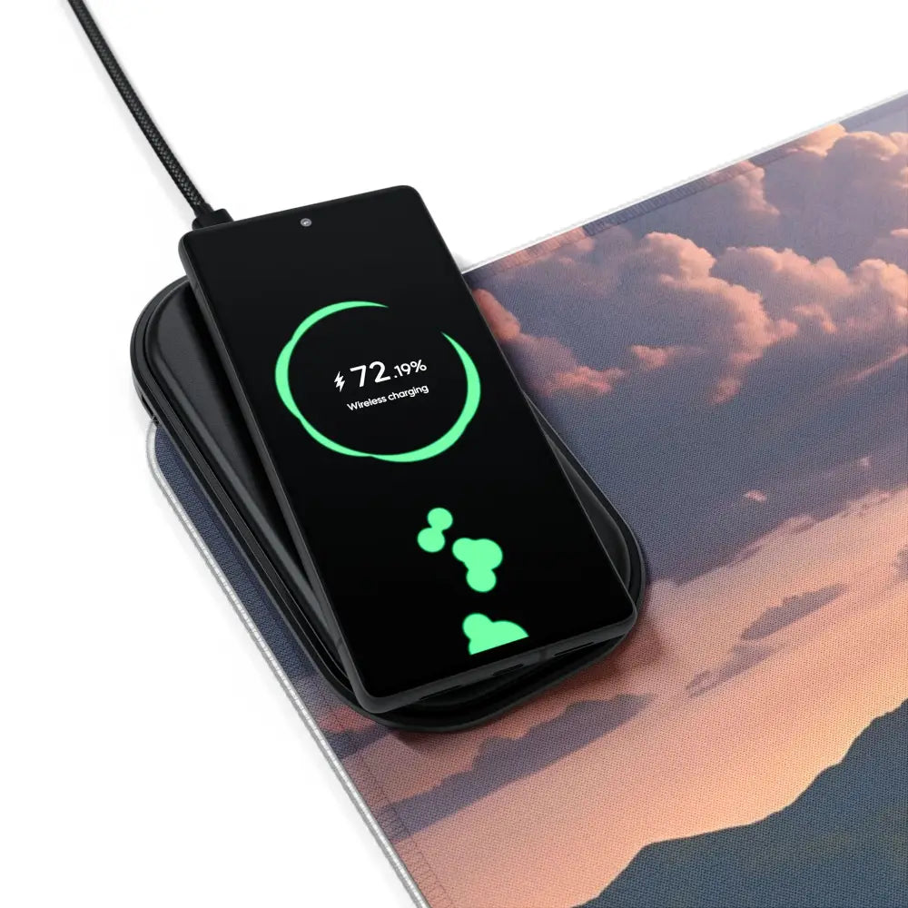 Black smartphone wirelessly charging on RGB Wireless Charging Mousepad The Edge of Dawn