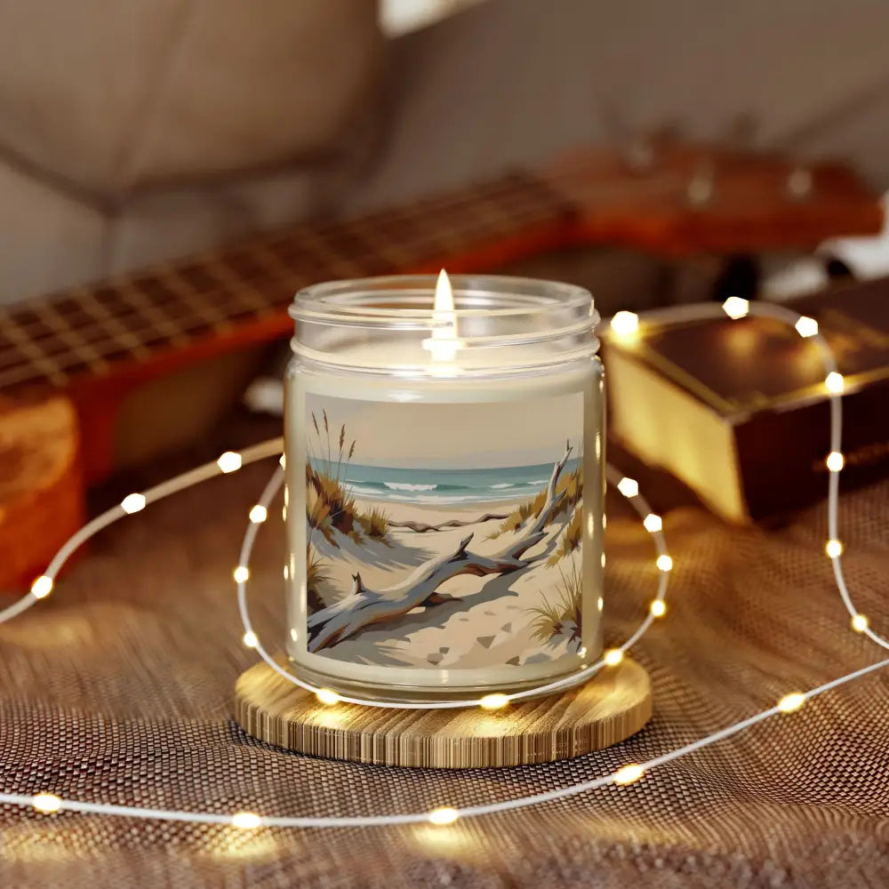 Beach-themed scented candle with lit wick from PixiOnyx Coastal Calm Series
