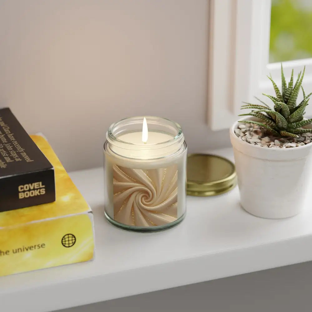 Lit scented candle in a glass jar with swirl design from PixiOnyx Cashmere Musk collection