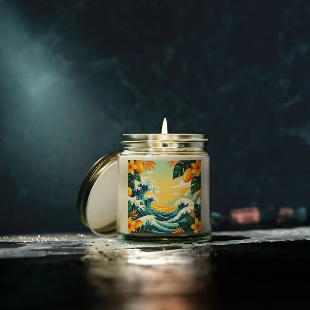 Lit candle in a jar with tropical wave design from Tropical Scented Candle Mango Coconut Escape
