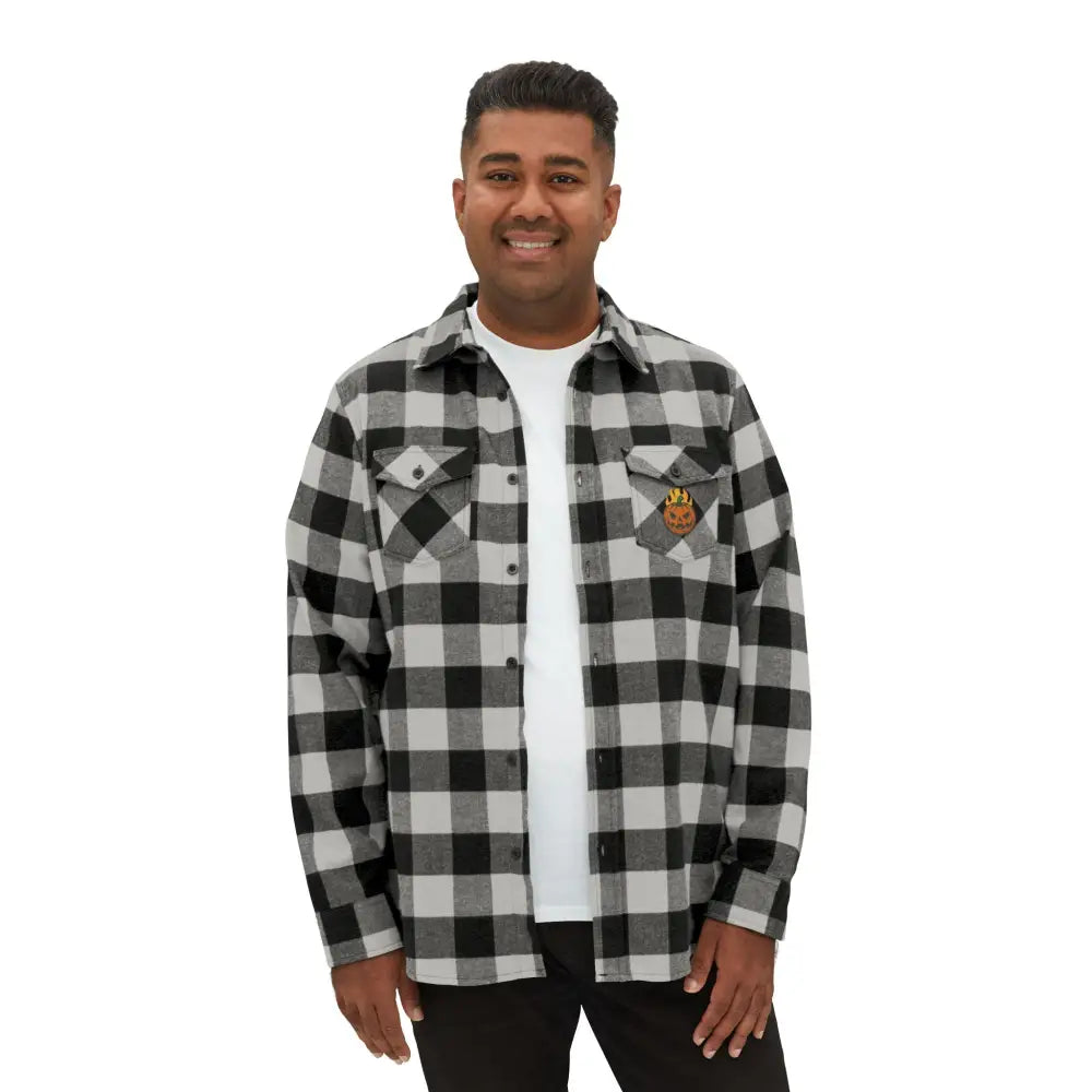 Men’s black and white plaid flannel shirt with flaming pumpkin emblem, perfect for Halloween style