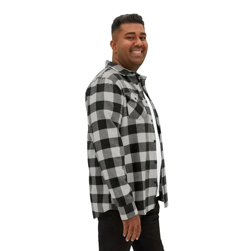 Man wearing black and white plaid flannel shirt with flaming pumpkin design for Halloween