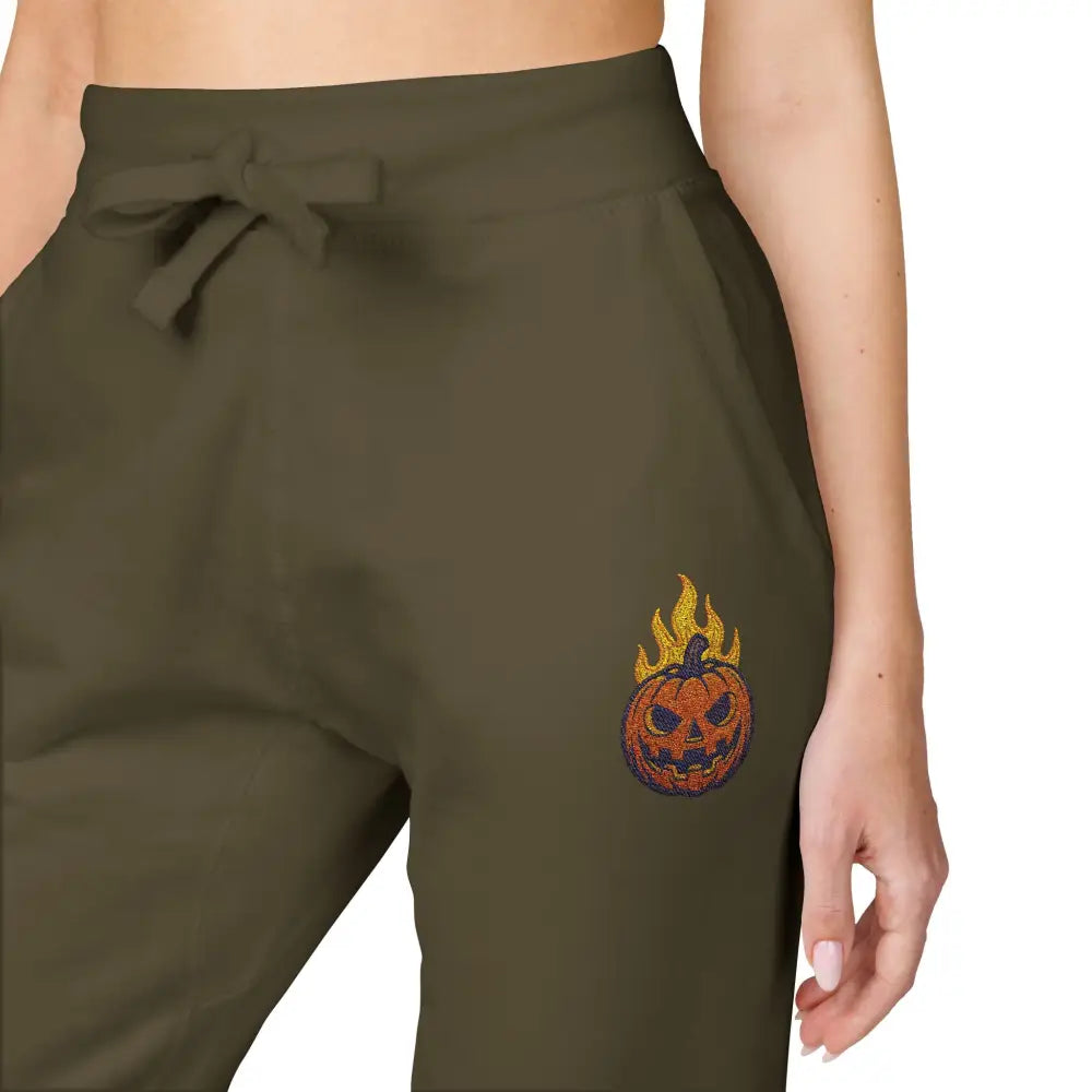 Olive green fleece sweatpants with flaming pumpkin design for cozy Halloween streetwear