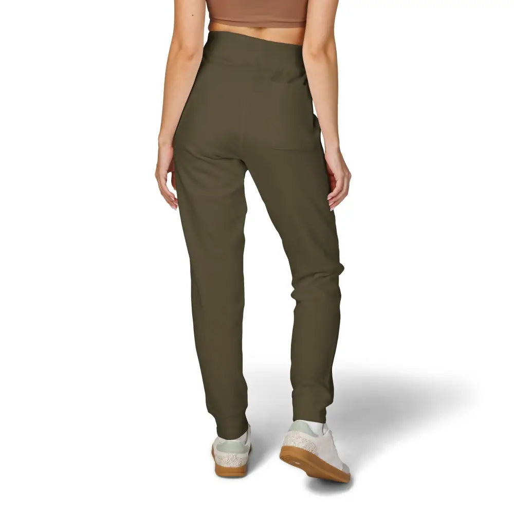 Woman wearing high-waisted fleece sweatpants with white and brown sneakers in Flaming Pumpkin style