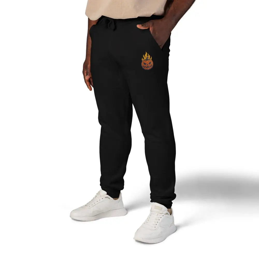 Black unisex fleece sweatpants with flaming pumpkin embroidery for cozy Halloween streetwear
