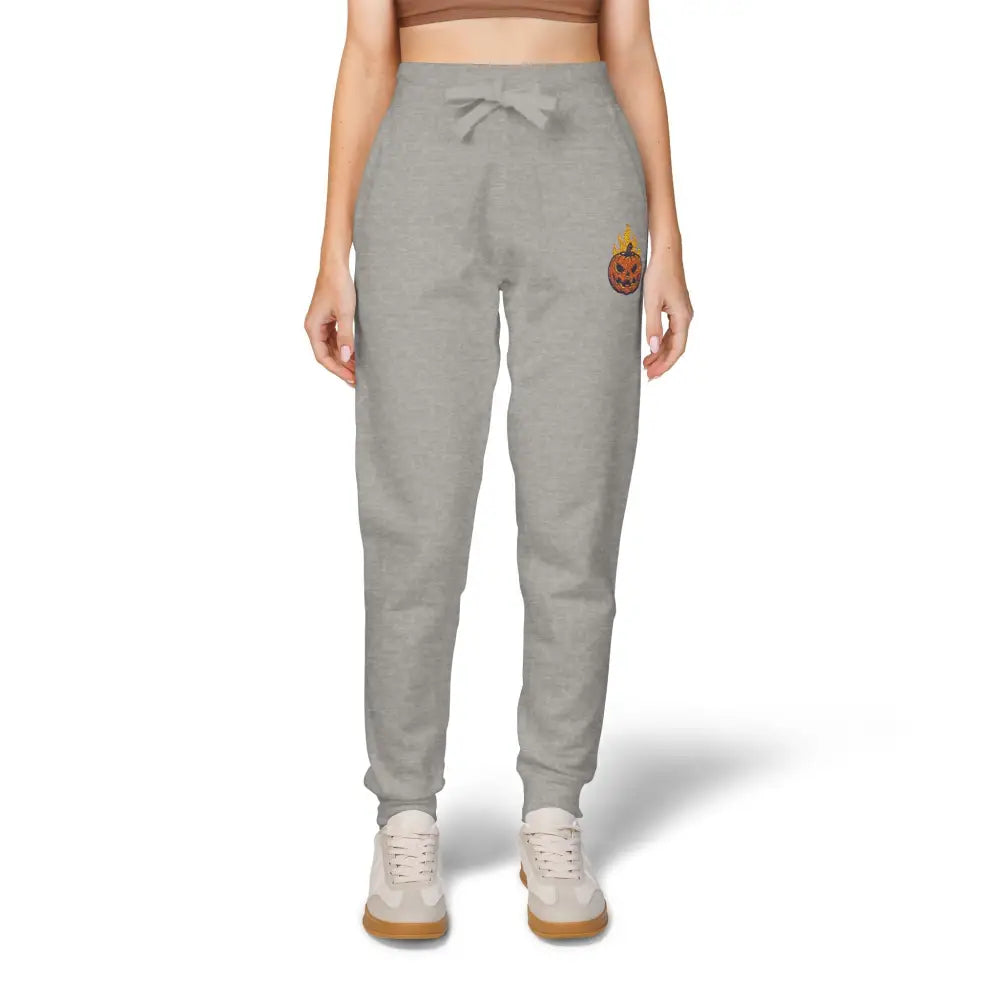 Gray fleece sweatpants with flaming pumpkin graphic on left thigh for cozy Halloween style