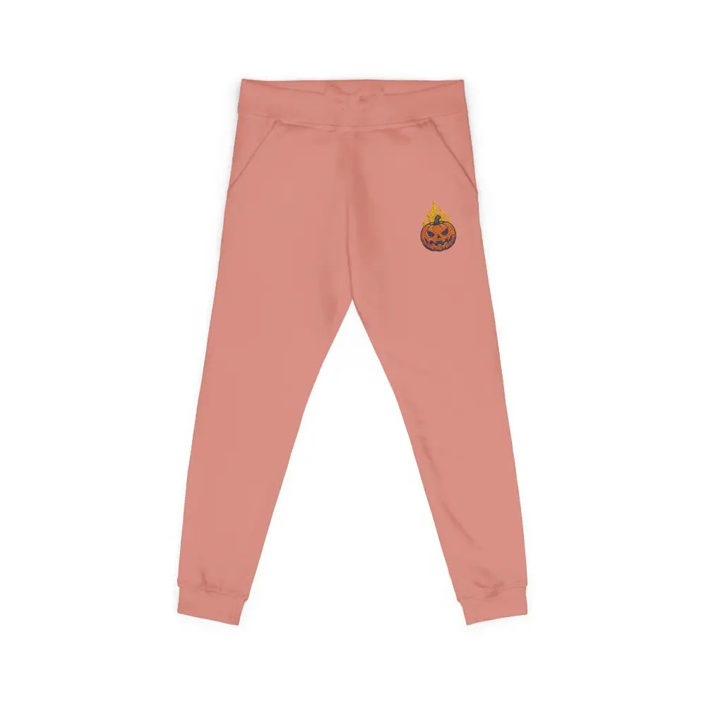 Pink fleece sweatpants with flaming pumpkin graphic for cozy Halloween streetwear