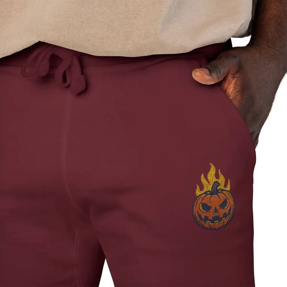 Maroon fleece sweatpants with flaming pumpkin design and drawstring for cozy Halloween style