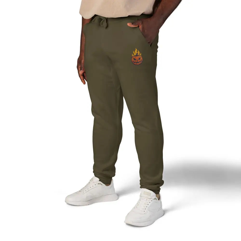 Olive green fleece sweatpants with flaming pumpkin emblem on left thigh for cozy Halloween style