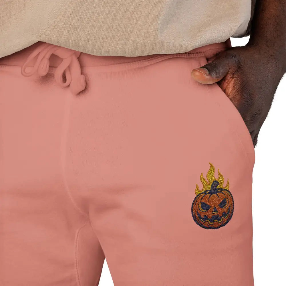 Pink fleece sweatpants with flaming pumpkin design for cozy Halloween streetwear