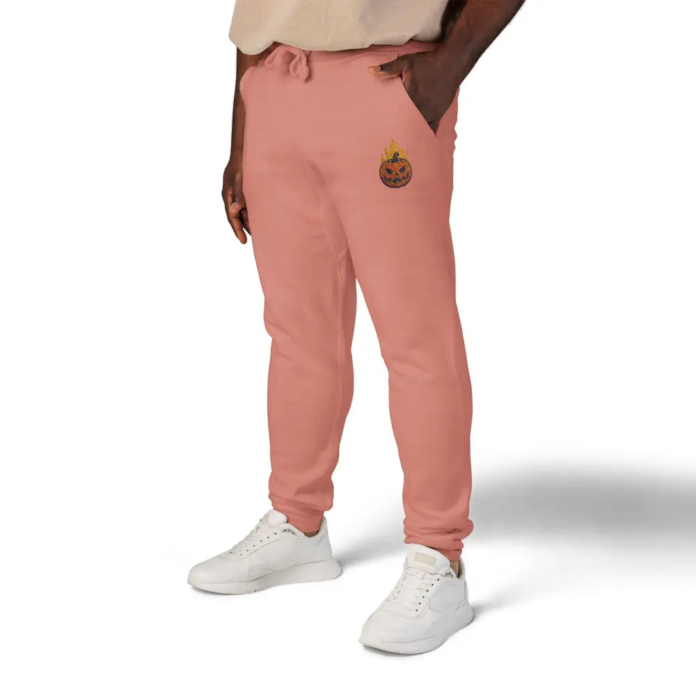 Pink fleece sweatpants with flaming pumpkin embroidery for cozy Halloween streetwear
