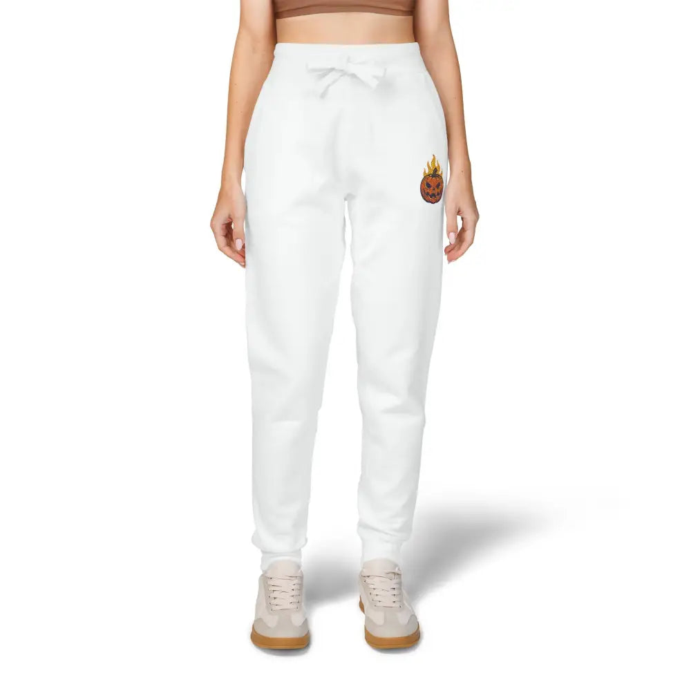 White women’s fleece sweatpants with flaming pumpkin and pineapple design on right leg