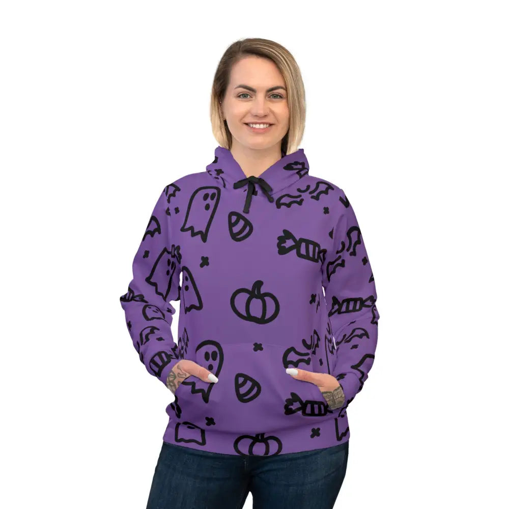 Woman wearing purple Halloween Ghosts Athletic hoodie with ghosts, candy, and pumpkin patterns