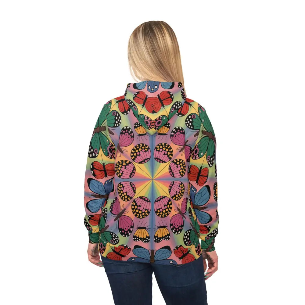 Woman wearing colorful butterfly-patterned unisex hoodie from Kaleidoscope Flight collection