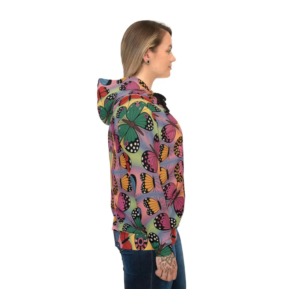 Woman in a colorful butterfly print Unisex Hoodie from Kaleidoscope Flight merges athletic versatility