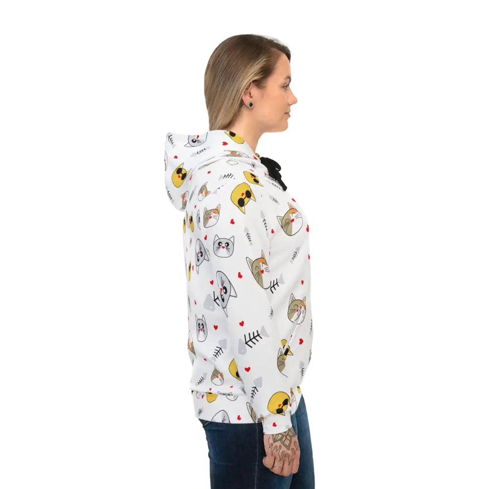 Woman wearing a cat-patterned hoodie from PixiOnyx Meowcore Drop Unisex Hoodie Paws Whiskers
