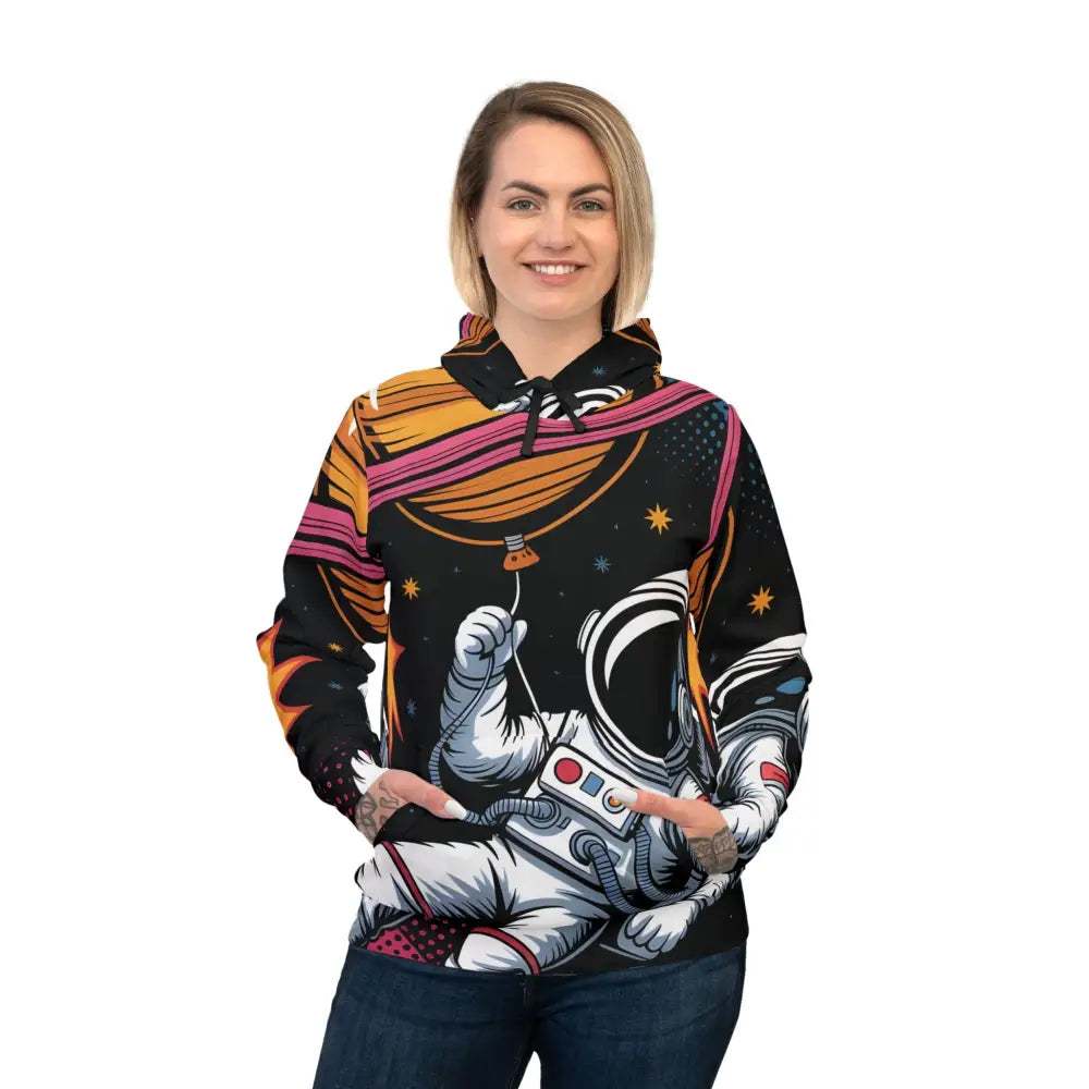 Woman in black hoodie with astronaut Saturn Balloon design from PixiOnyx AstroDrift Series