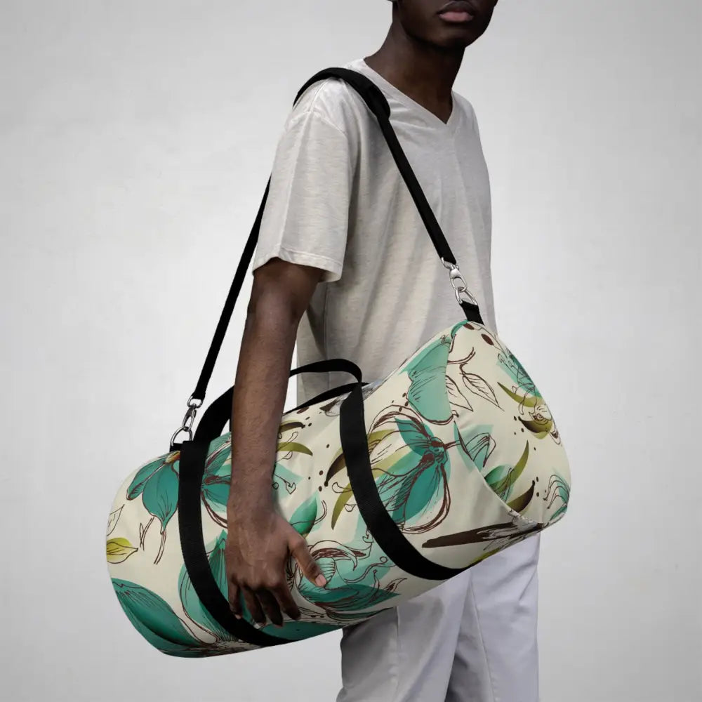 White duffel bag with teal floral pattern and black straps in Duffel Bags collection
