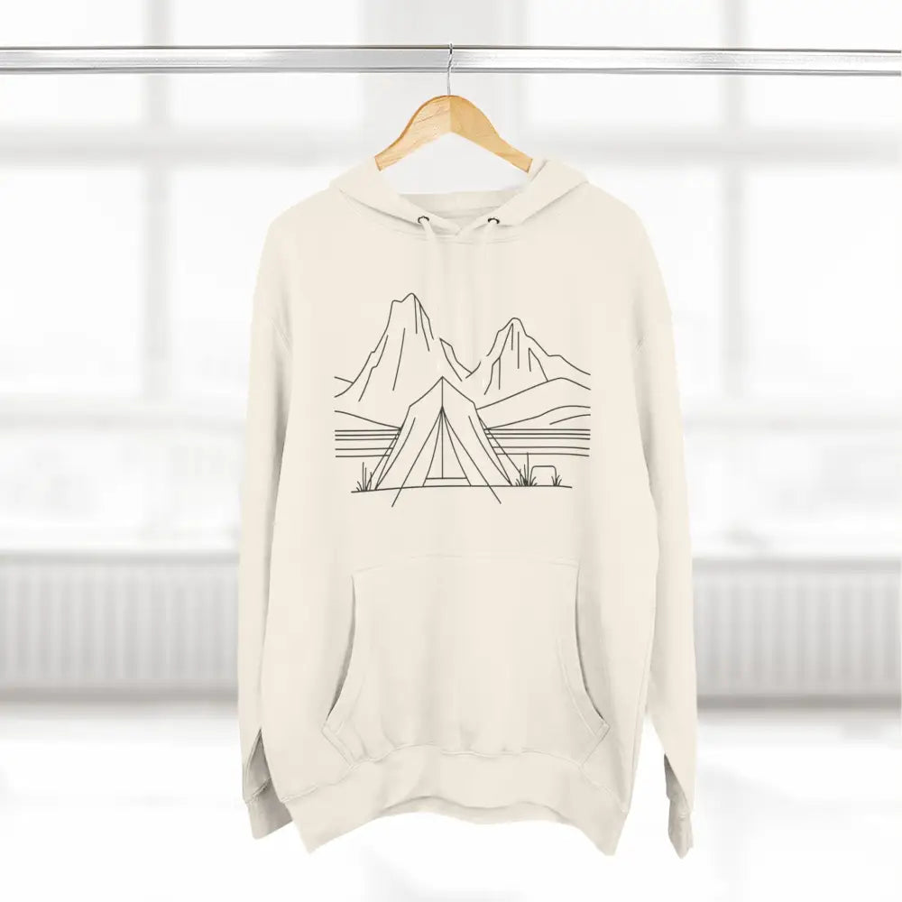 Cream-colored unisex hoodie with line art tent and mountains design, luxurious fleece, spacious kangaroo pocket
