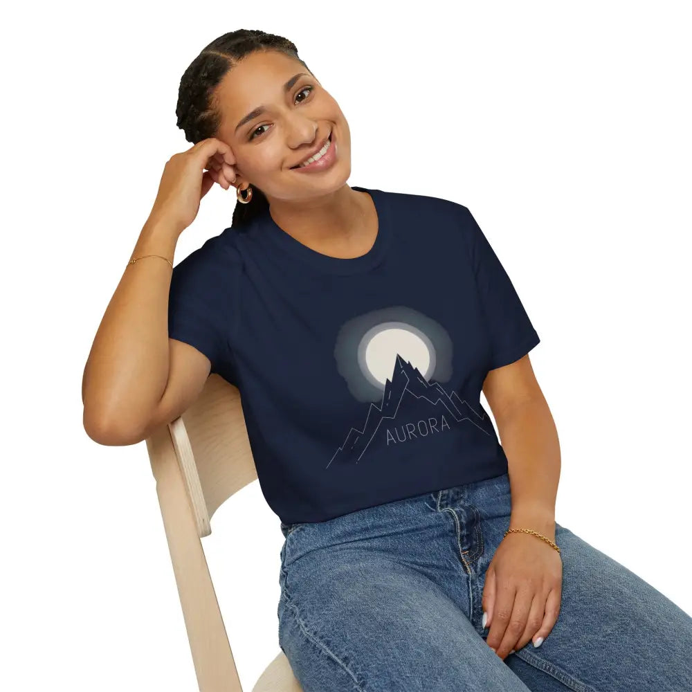 Woman wearing Aurora Mountain Unisex Softstyle T-Shirt with mountain and moon graphic