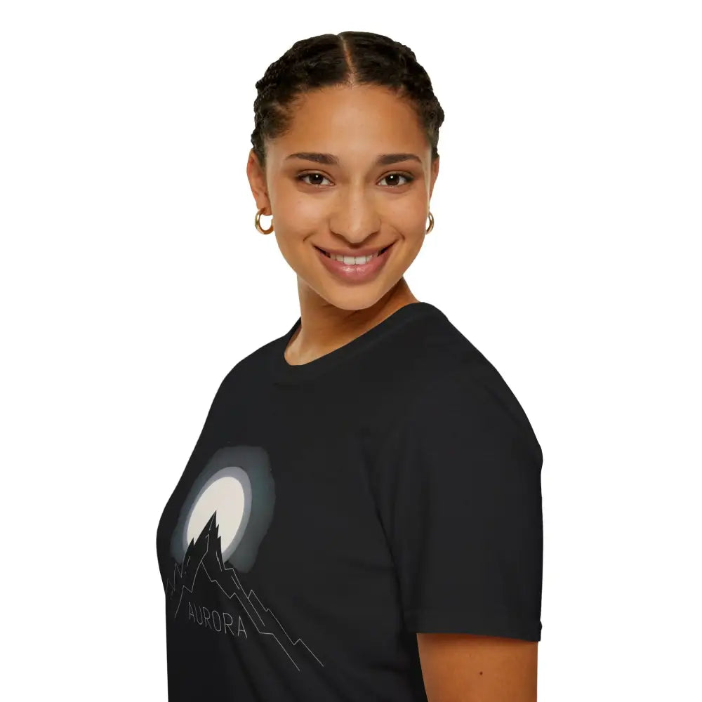Woman wearing Aurora Mountain Unisex Softstyle T-Shirt with mountain and moon graphic, ribbed knit collar
