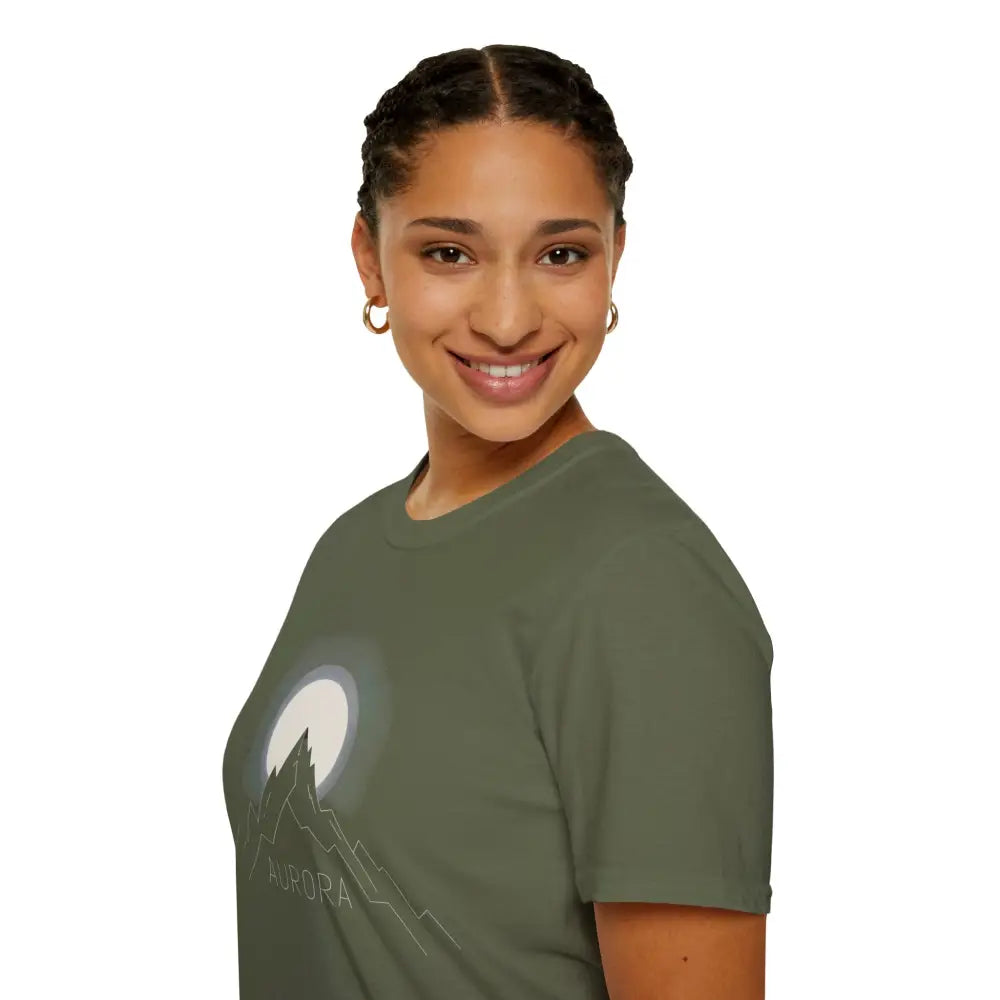 Smiling woman with braided hair wearing Aurora Mountain Unisex T-Shirt with mountain and moon graphic