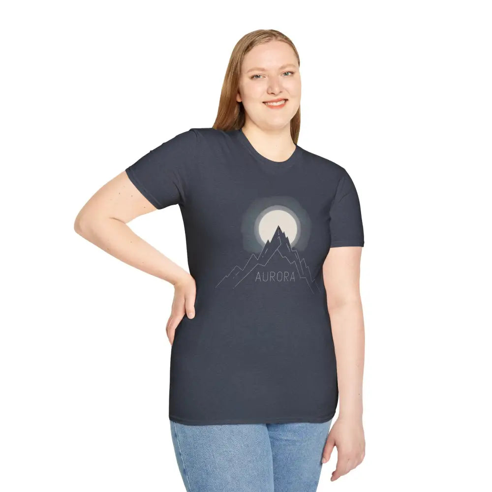 Woman wearing Aurora Mountain Unisex Softstyle T-Shirt with mountain and moon graphic