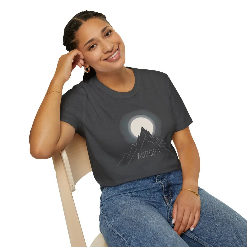 Woman wearing Aurora Mountain Unisex Softstyle T-Shirt with mountain and moon design