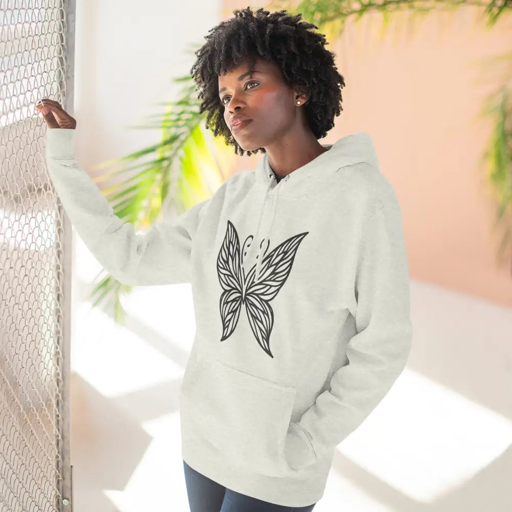 Woman modeling white fleece hoodie with black butterfly design, casual fall fashion