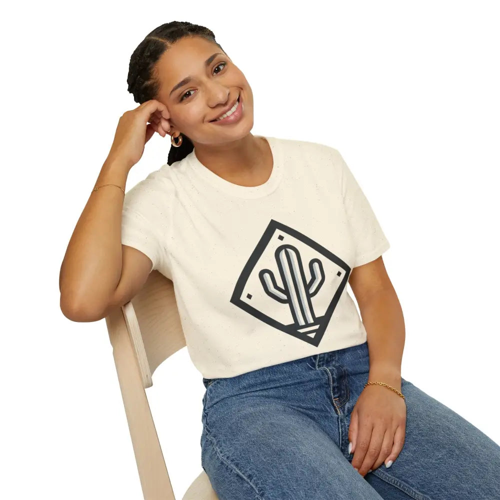 Woman in cream-colored Cactus Adventure T-Shirt with black cactus logo and blue jeans, made from ring-spun cotton for ultimate comfort and reduced fabric waste