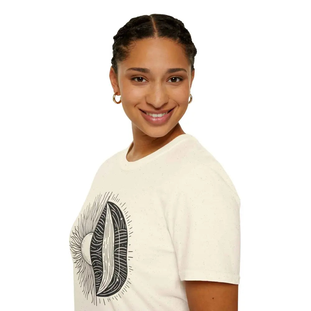 Woman wearing a cream-colored unisex softstyle t-shirt with a black and white graphic design